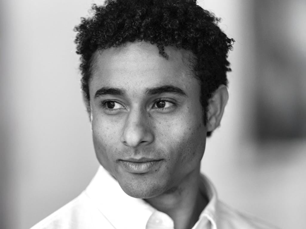 A black and white headshot of Patricio Revé