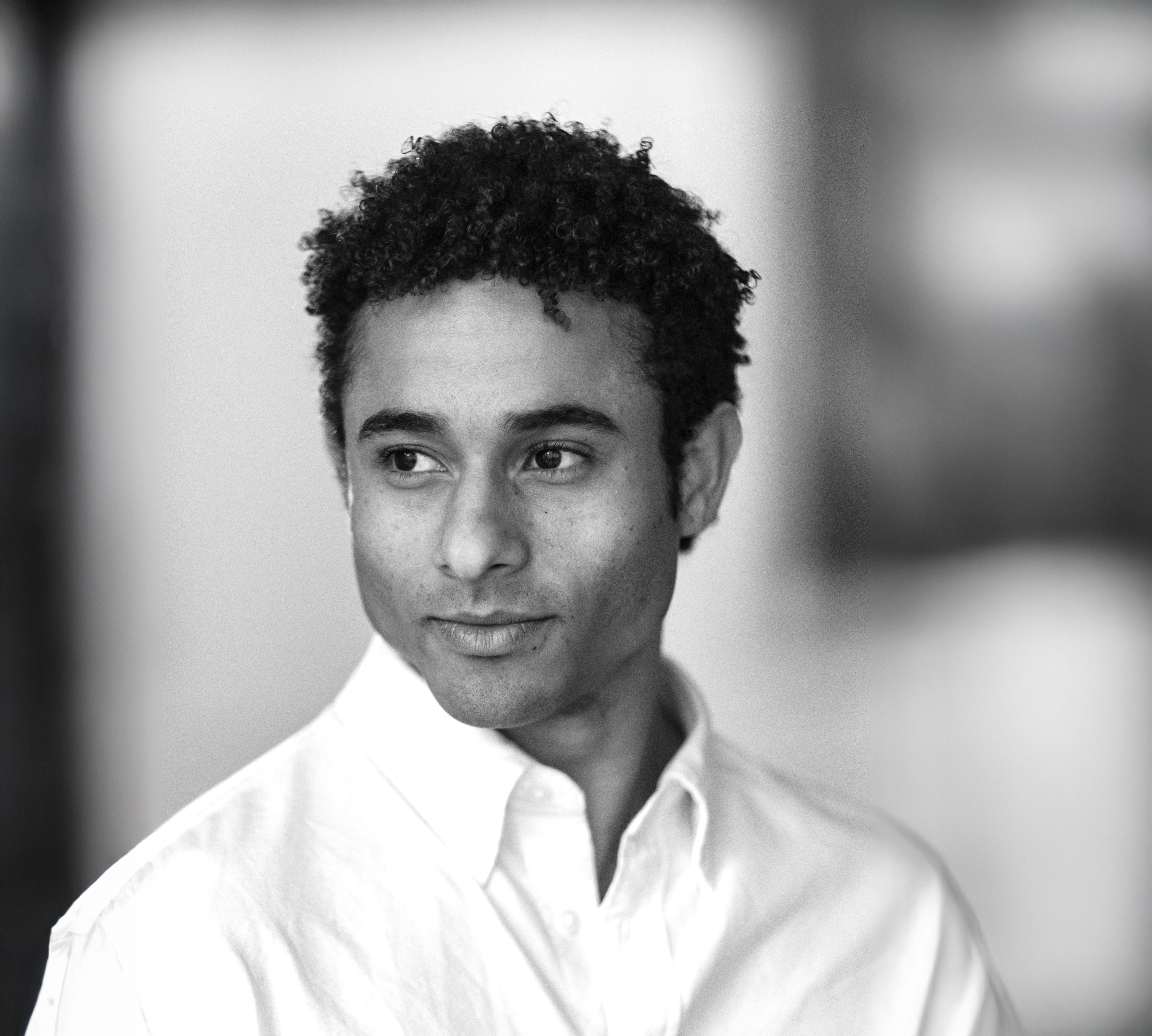 A black and white headshot of Patricio Revé