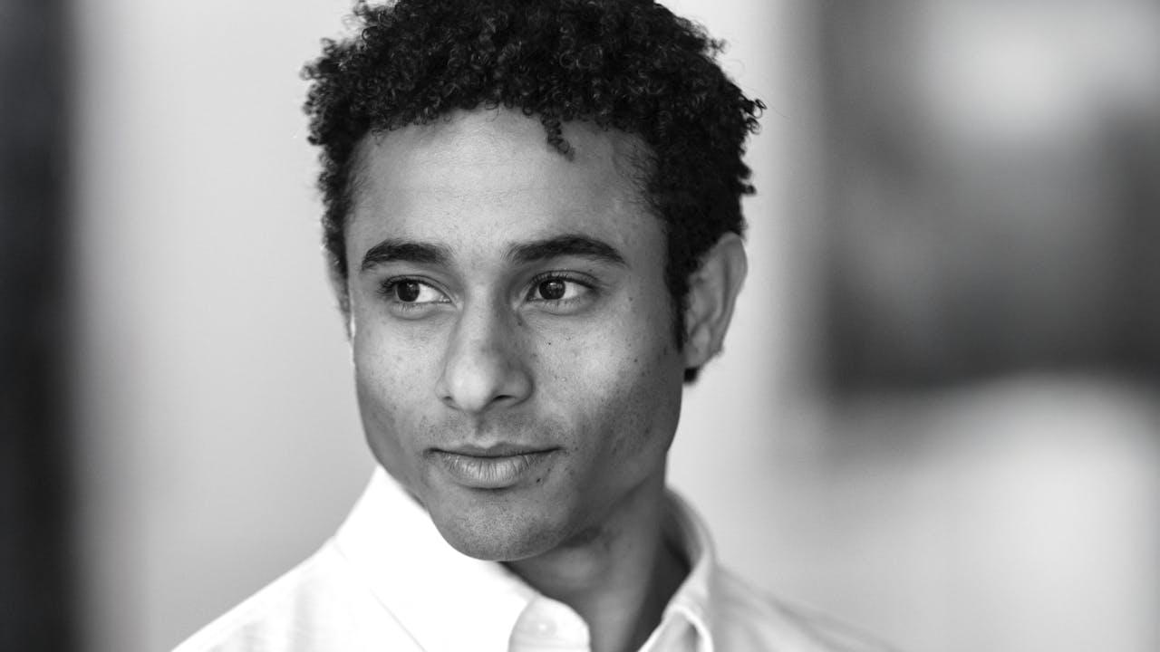 A black and white headshot of Patricio Revé