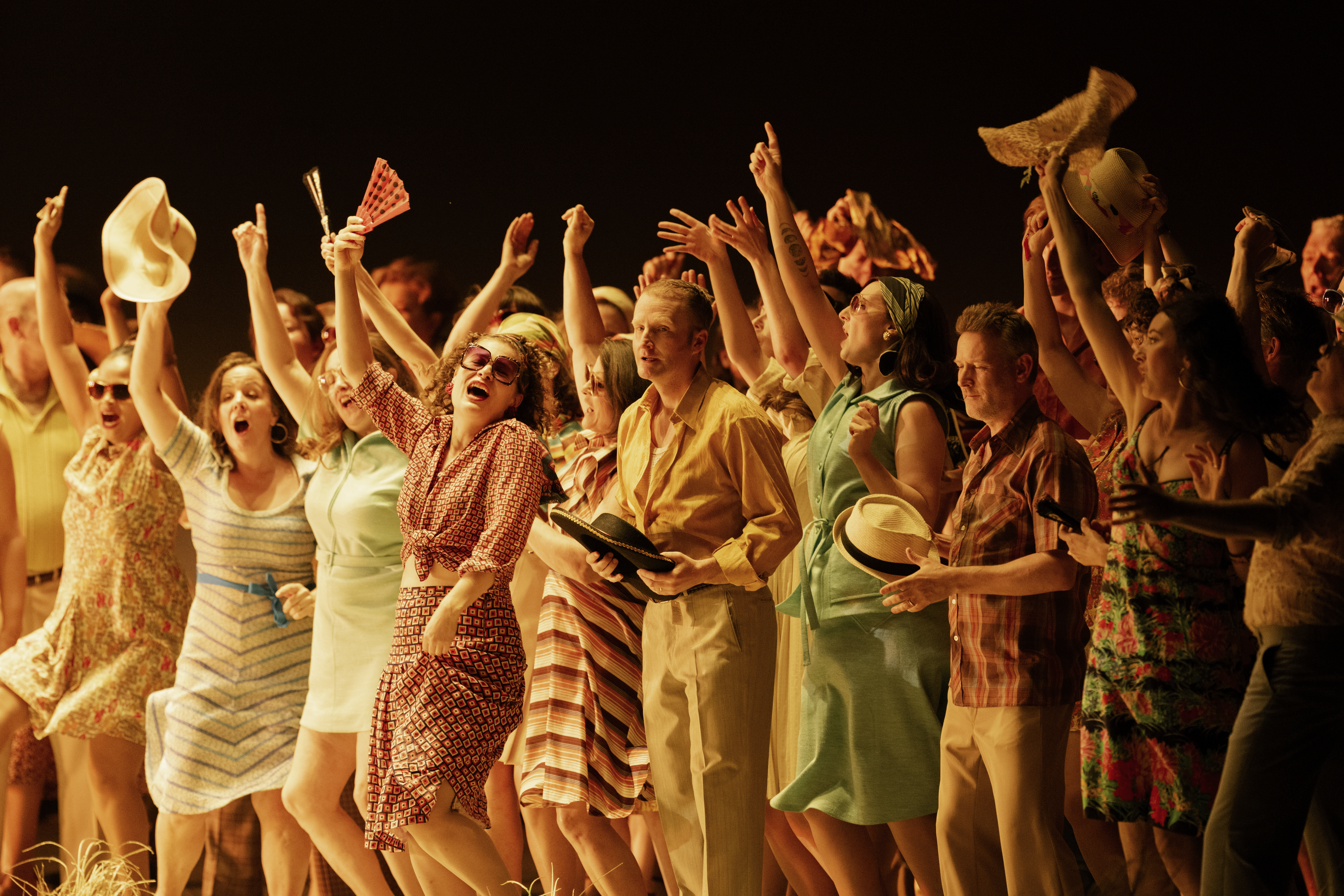 A chorus of brightly dressed singers performing jubilantly on stage in The Royal Opera's production of Carmen. (5 of 7)