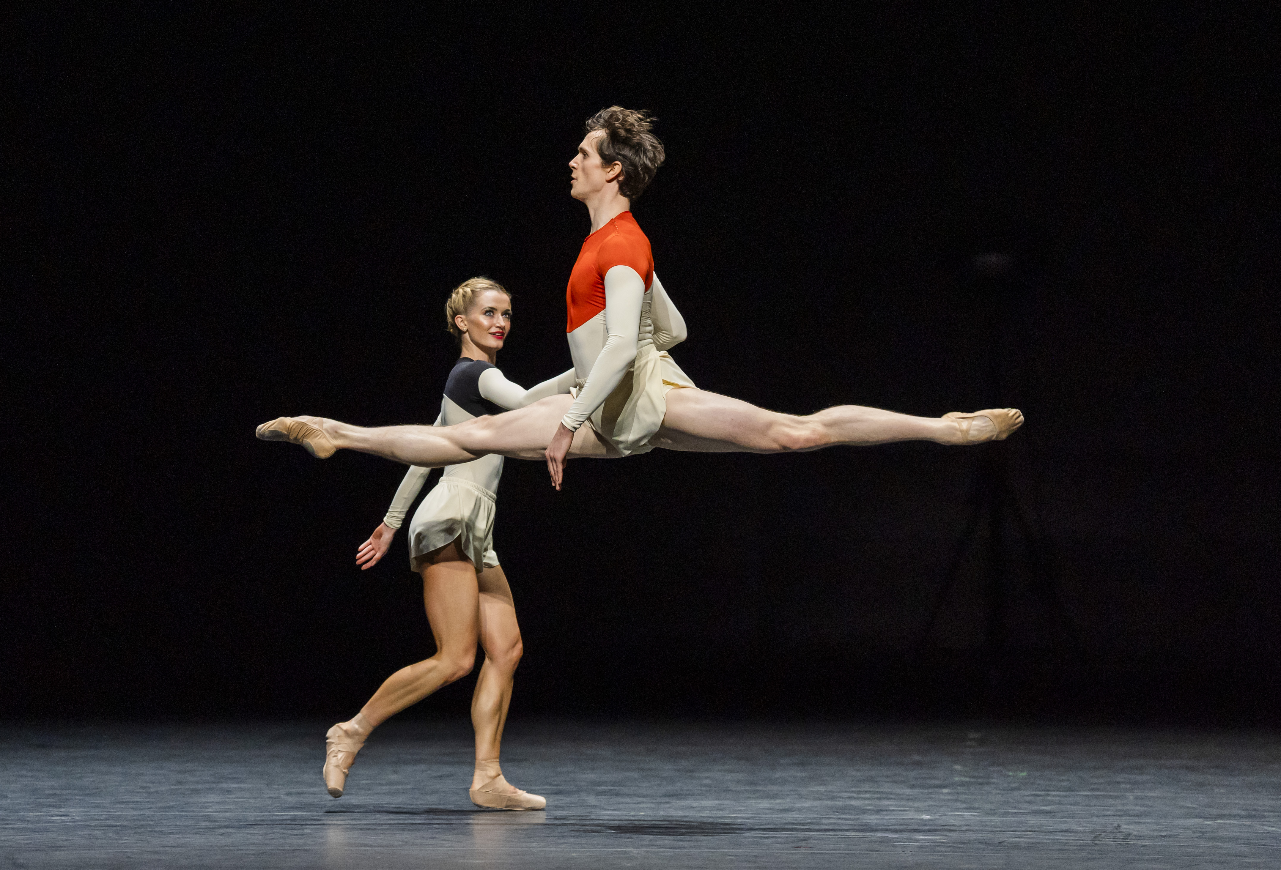 The Royal Ballet Dancers Anna Rose O'Sullivan and William Bracewell perform on stage. William Bracewell launches into the air with his legs vertical in a split. (2 of 8)