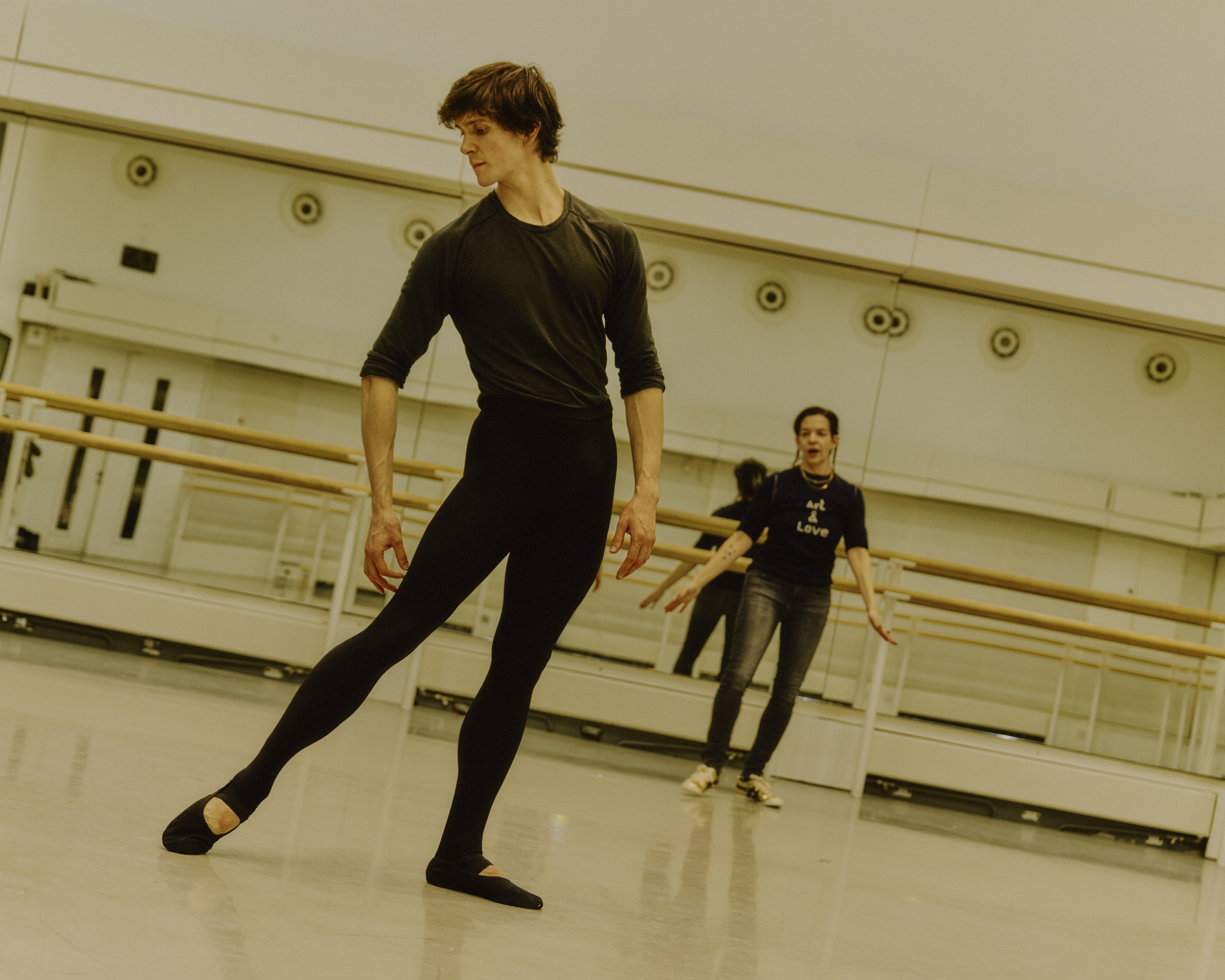 The The Royal Ballet dancer William Bracewell rehearses in a ballet studio with the choreographer Pam Tanowitz guiding him from behind. (4 of 4)