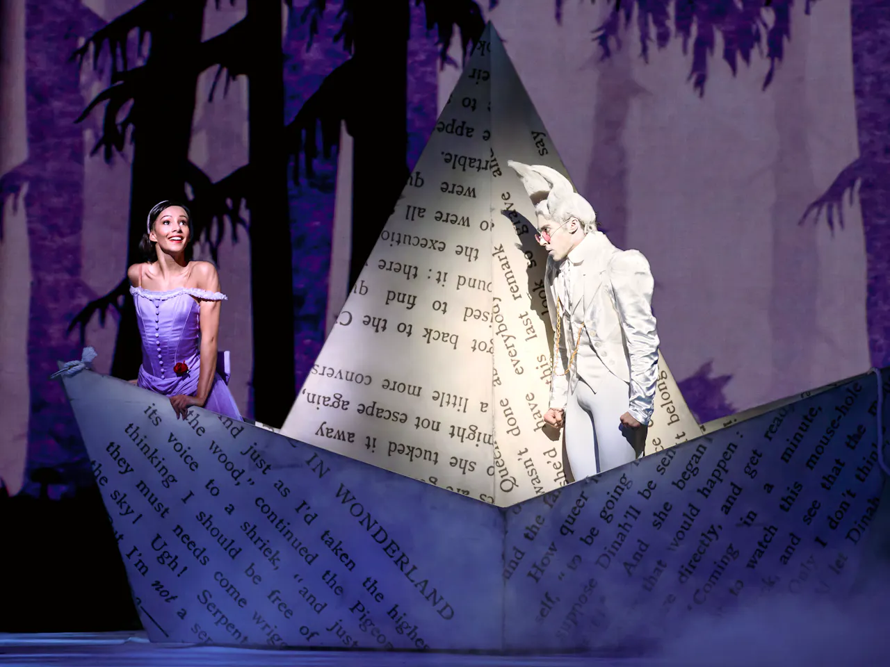 Alice and the White Rabbit stand in a boat made of paper