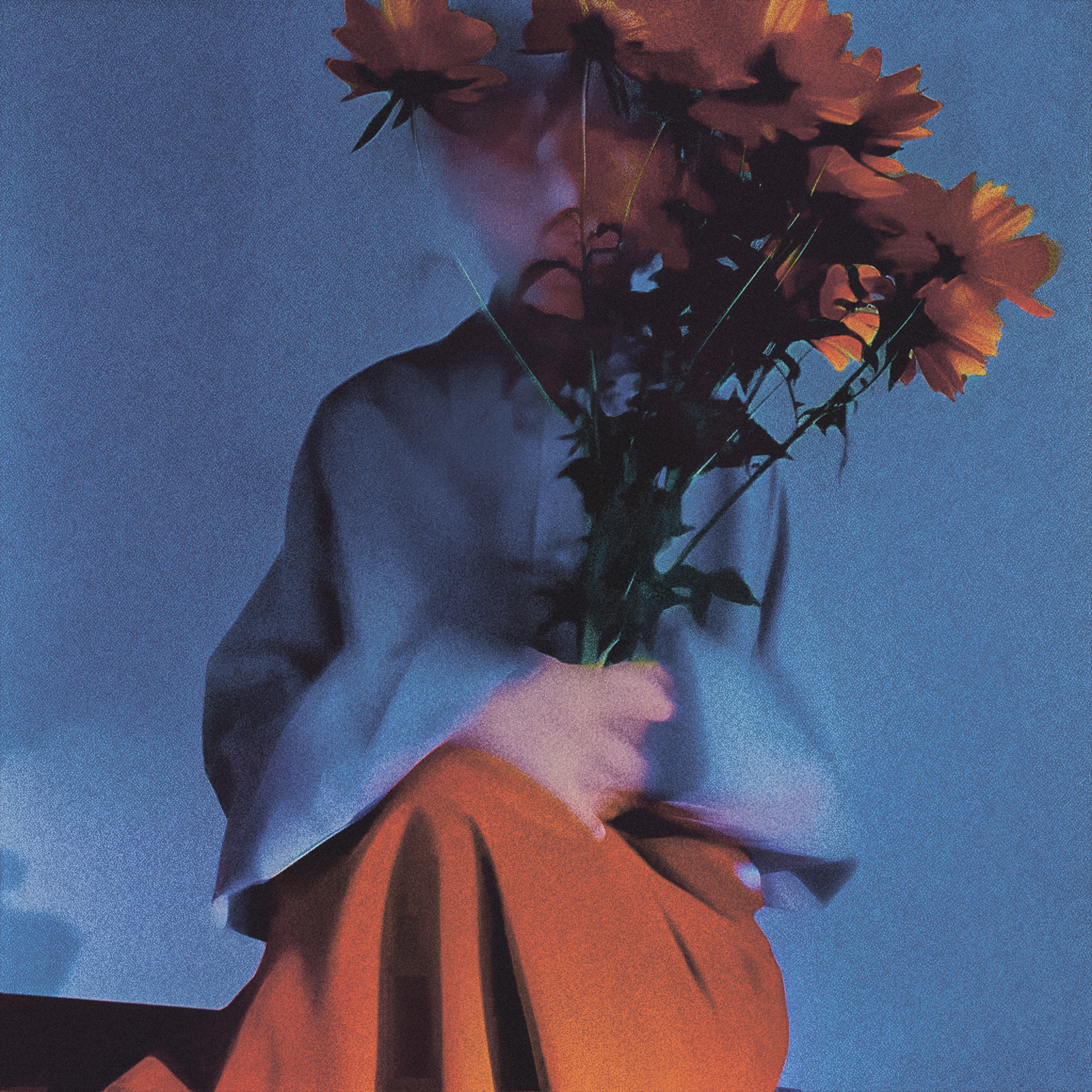A stylized, grainy photograph of a person sitting against a blue-toned background, holding a bouquet of orange flowers that obscures their face. The person wears a muted blue top and a flowing orange skirt, with soft, moody lighting and a dreamy, slightly blurred effect.