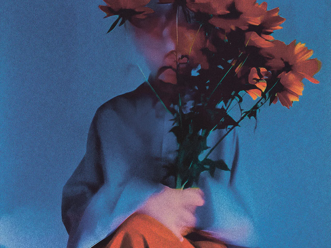 A stylized, grainy photograph of a person sitting against a blue-toned background, holding a bouquet of orange flowers that obscures their face. The person wears a muted blue top and a flowing orange skirt, with soft, moody lighting and a dreamy, slightly blurred effect.