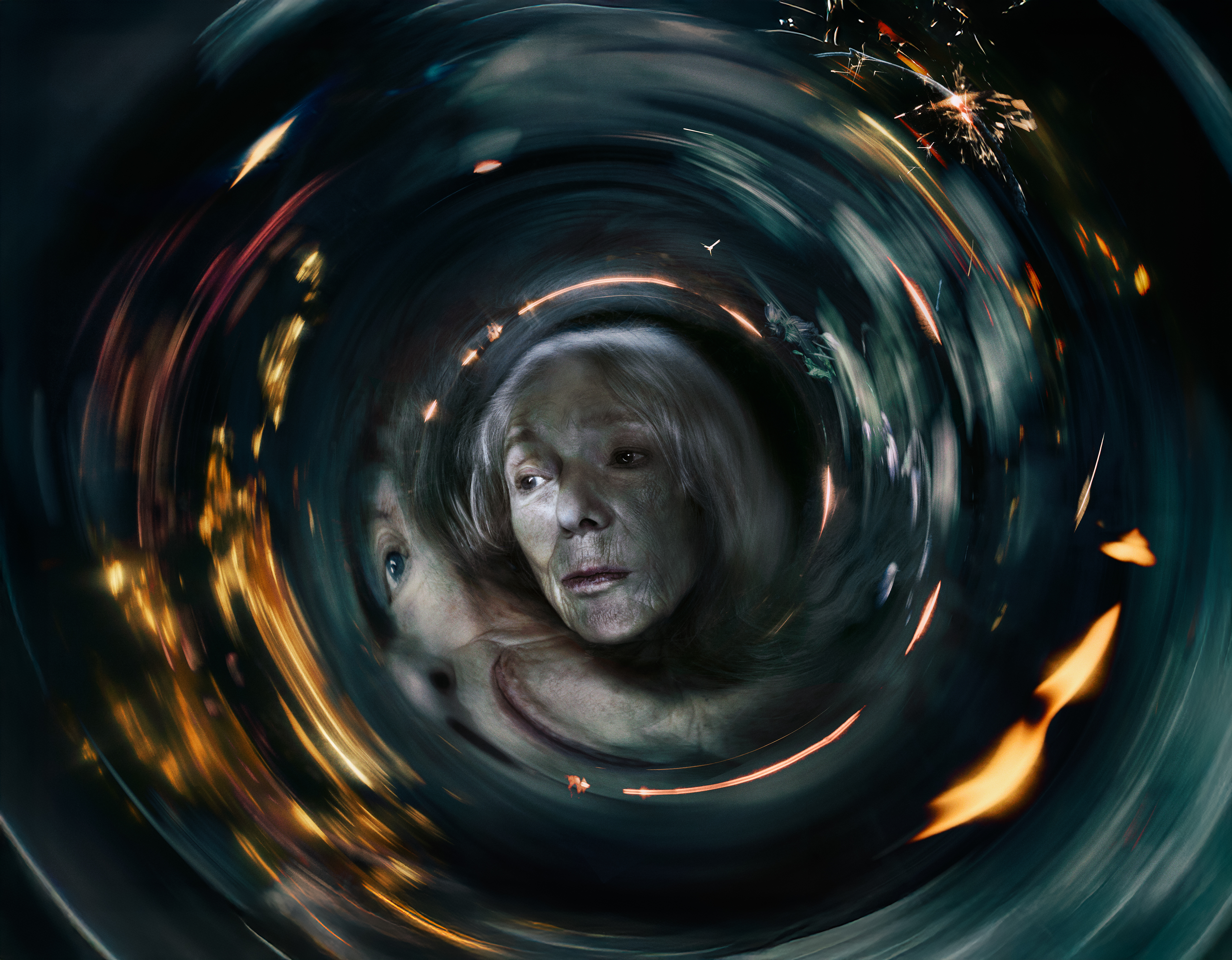 An elderly woman representing Erda in Barrie Kosky’s Götterdämmerung is at the centre of the frame. The woman’s expression is somber, she has pale skin and grey hair and is seen through a swirling, surreal, tunnel-like vortex. The scene is distorted as if viewed through spinning glass, with streaks of light, sparks, and warm glowing fragments spiralling around her.