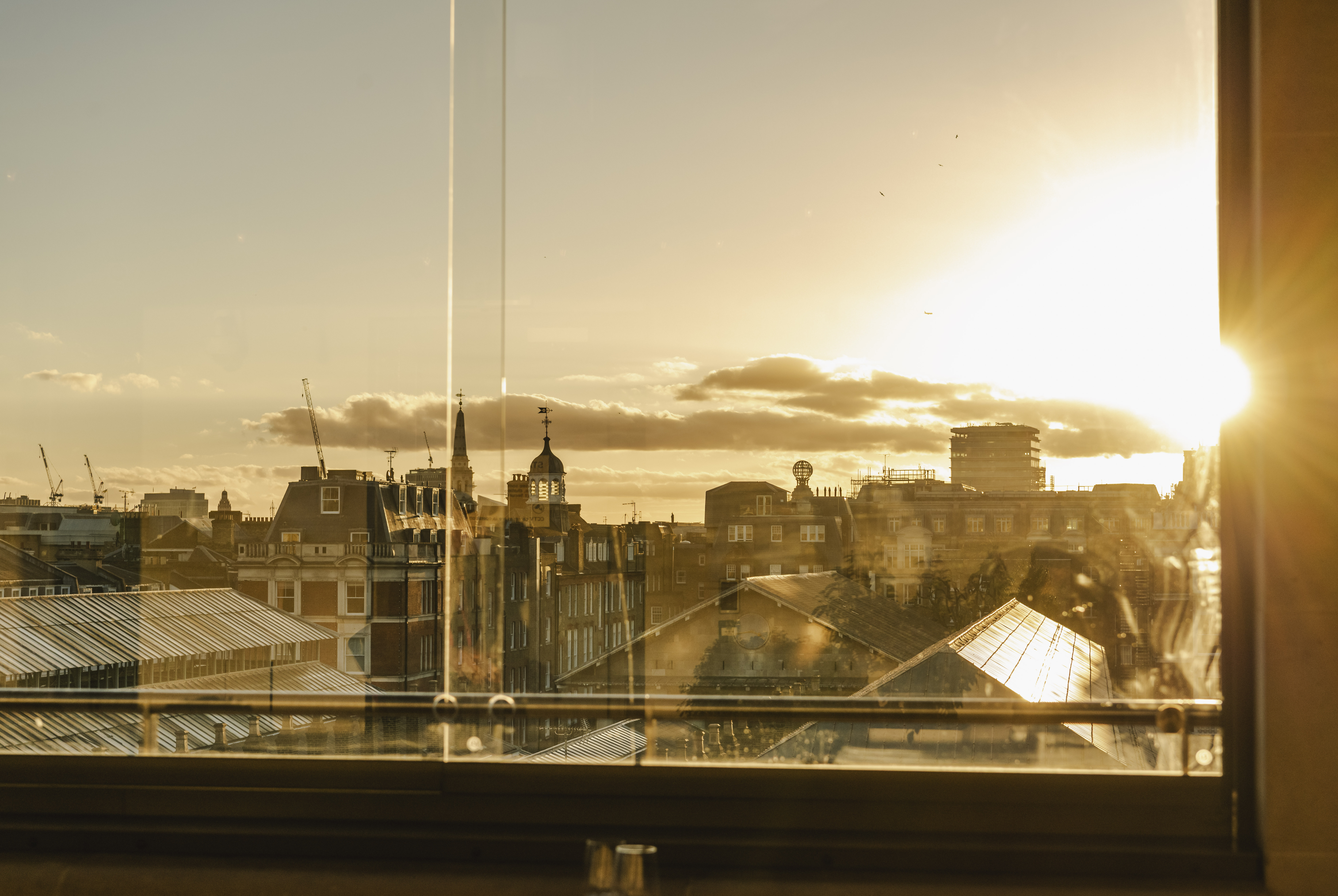 Sunset over Covent Garden piazza through clear windows.