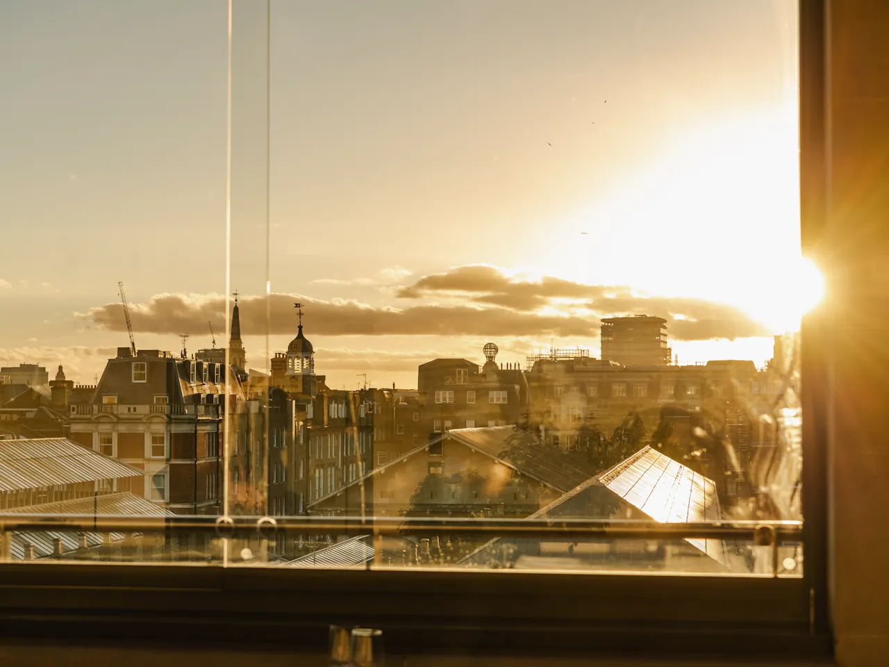 Sunset over Covent Garden piazza through clear windows.