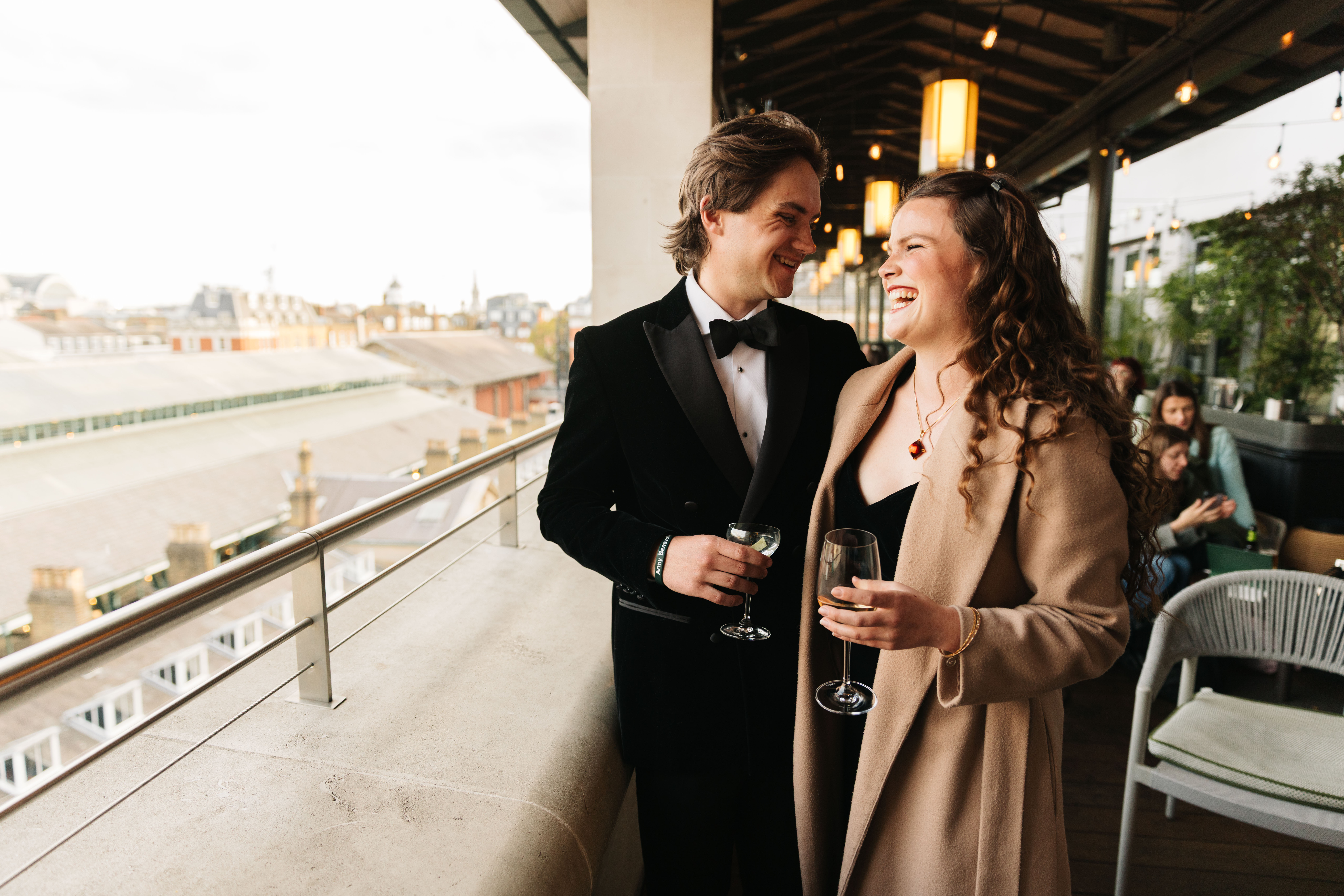 Two people in smart evening-wear look out over the piazza of Covent Garden. (9 of 9)