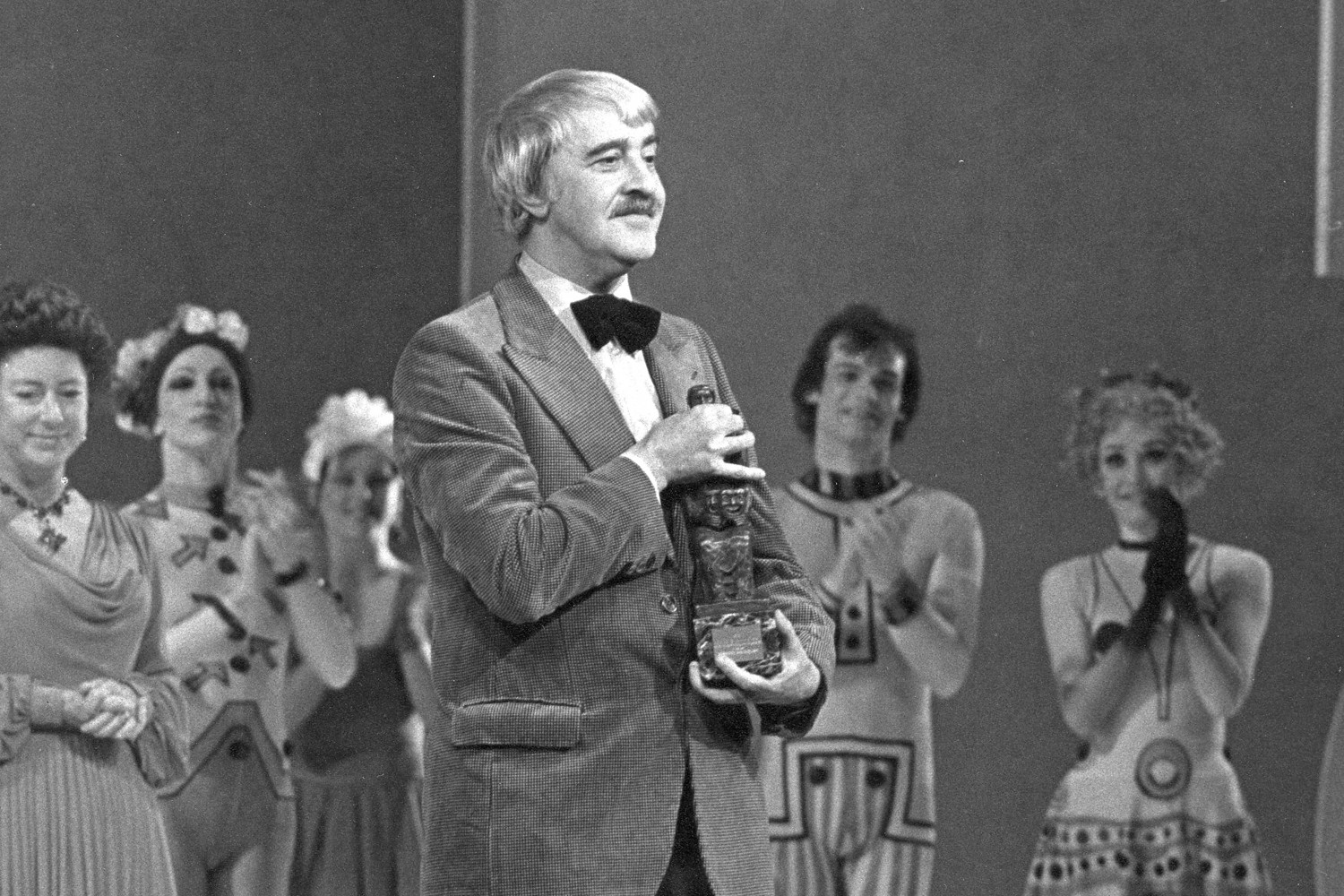 Kenneth MacMillan being presented with an award onstage.