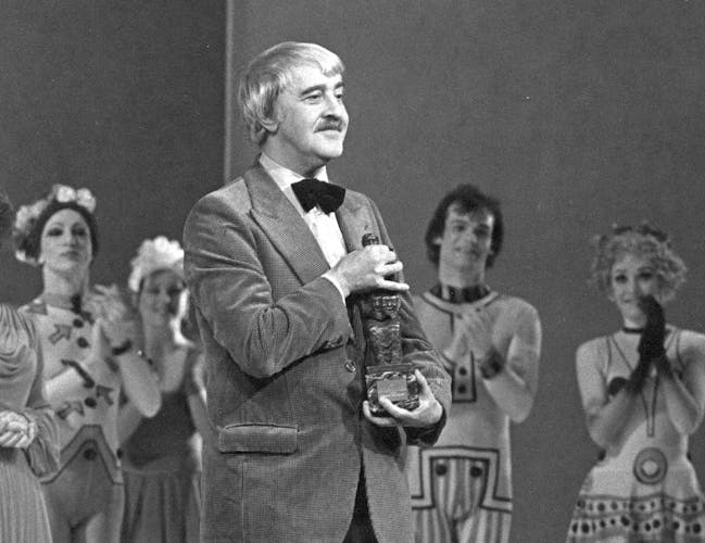 Kenneth MacMillan being presented with an award onstage.