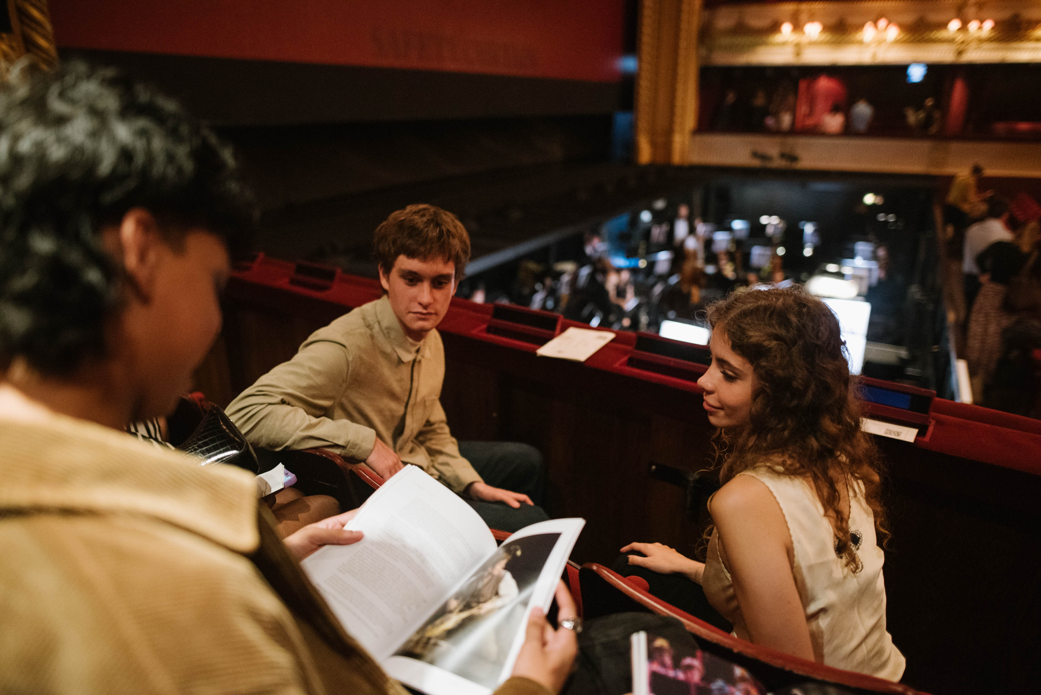 Two audience members sitting in the main auditorium of the Royal Opera House.