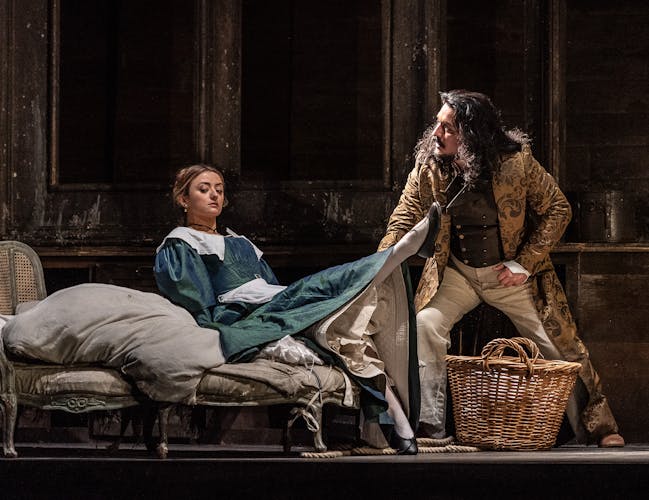 Two cast members onstage during a performance of The Marriage of Figaro.