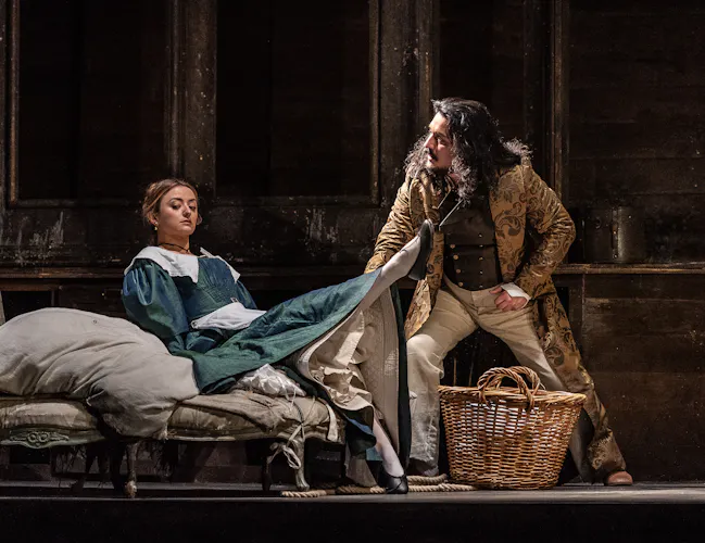 Two cast members onstage during a performance of The Marriage of Figaro.