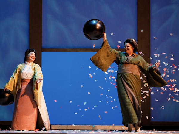 Kseniia Nikolaieva and Lianna Haroutounian throwing cherry blossoms onstage.
