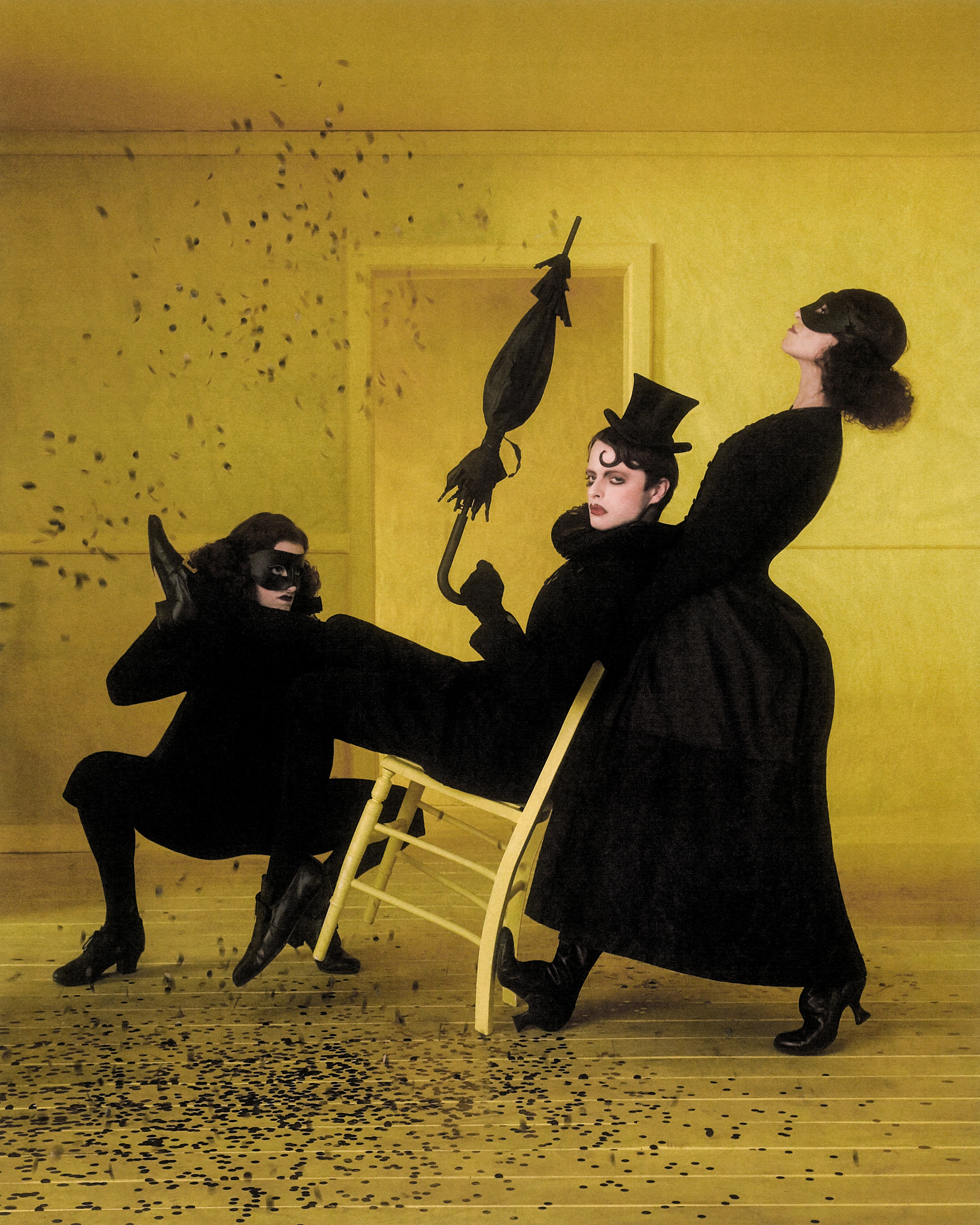 Dark figures appear as shadows in a yellow room. One of them holds a red envelope containing an invite. (1 of 4)
