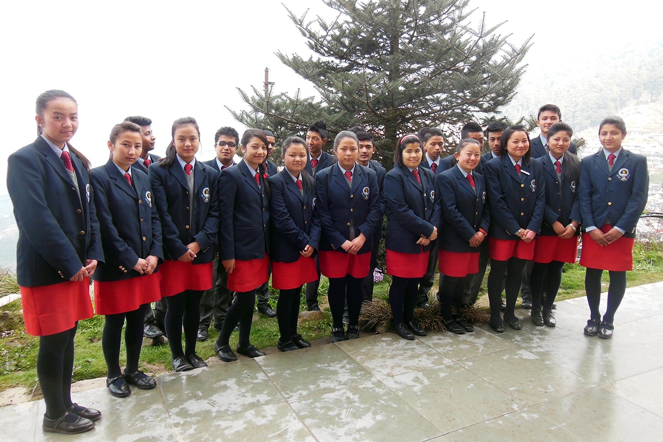 United in Education, United in Nature: Grade 11 students stand proudly in their uniforms, surrounded by the majestic mountains that symbolize their journey of growth and learning at our school.