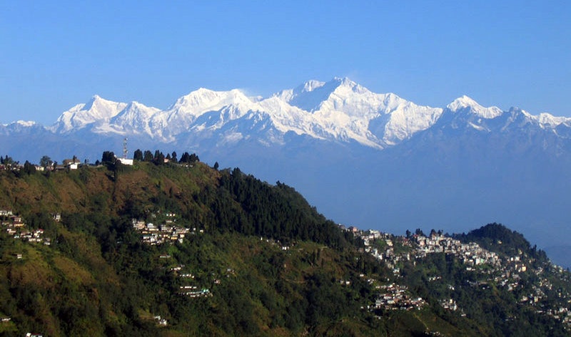 Awe-Inspiring Beauty: The breathtaking Kanchenjunga range majestically frames the enchanting town of Darjeeling. A mesmerizing vista from Tiger Hill, capturing the essence of nature's grandeur and the serenity of this remarkable locale.