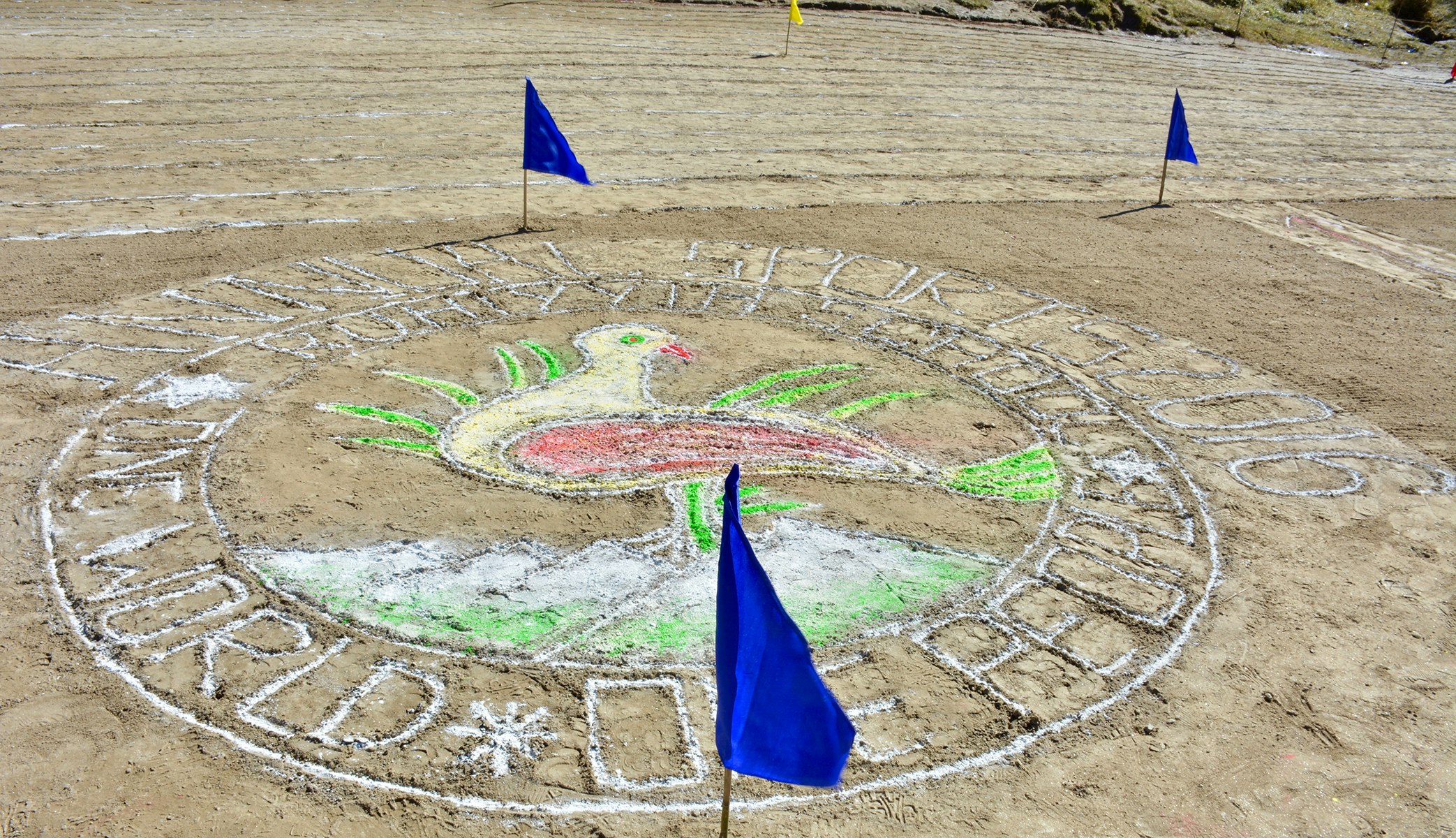 Unity in Diversity: The vibrant peacock logo of our school, adorned with the empowering message 'One World, One People,' takes center stage, etched beautifully on the ground with chalk, embraced by the spirit of togetherness and celebrated on sports day.