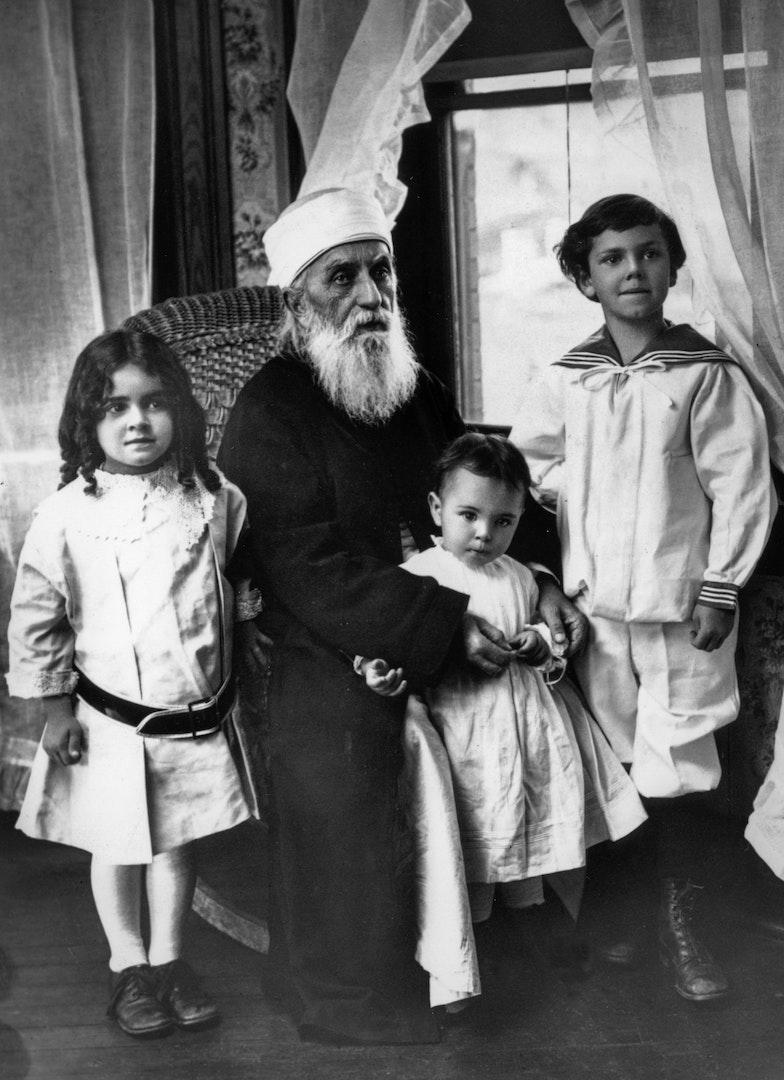 ‘Abdu’l-Bahá with three children, 1912