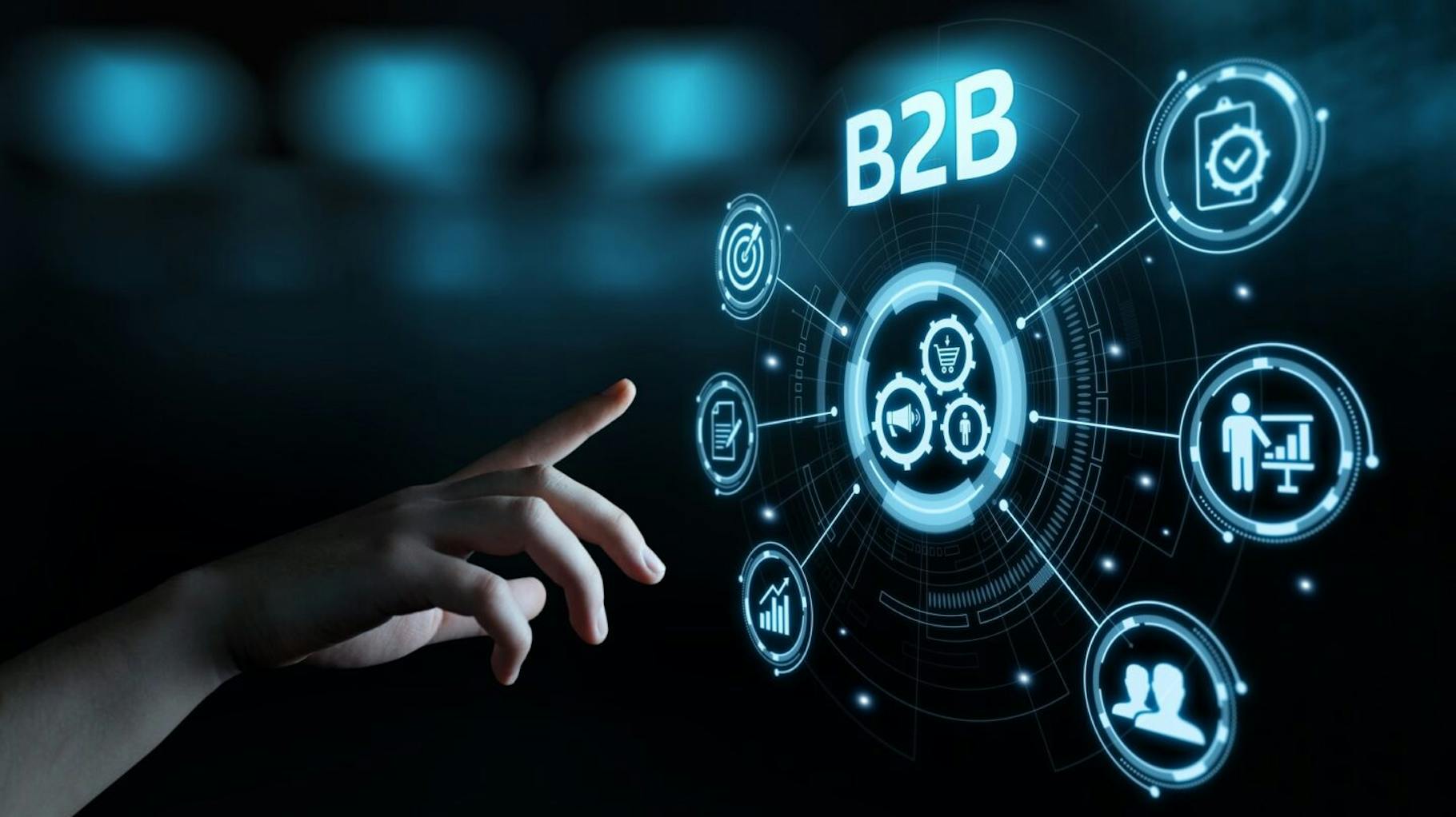 The graphic shows a hand with a screen on B2B motifs for B2B marketing.