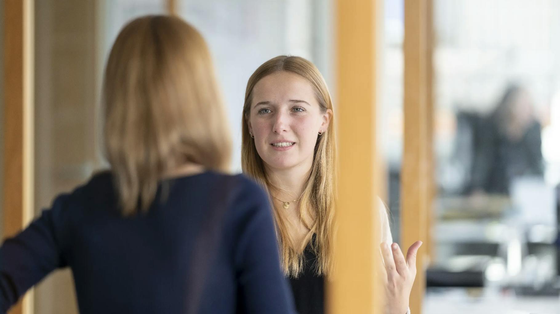 Two employees discuss a sustainability strategy