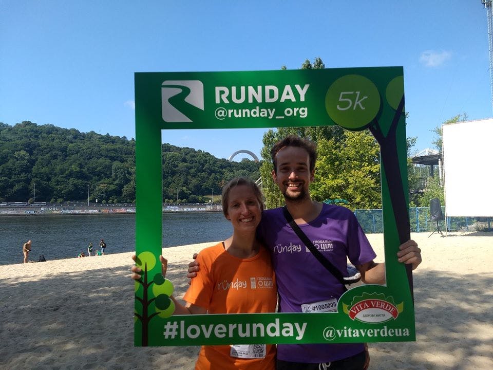 Pictured: a married couple of Runday runners on Trukhaniv Island are photographed after the race with Runday advertising, @runday_org, by @vitaverdeua