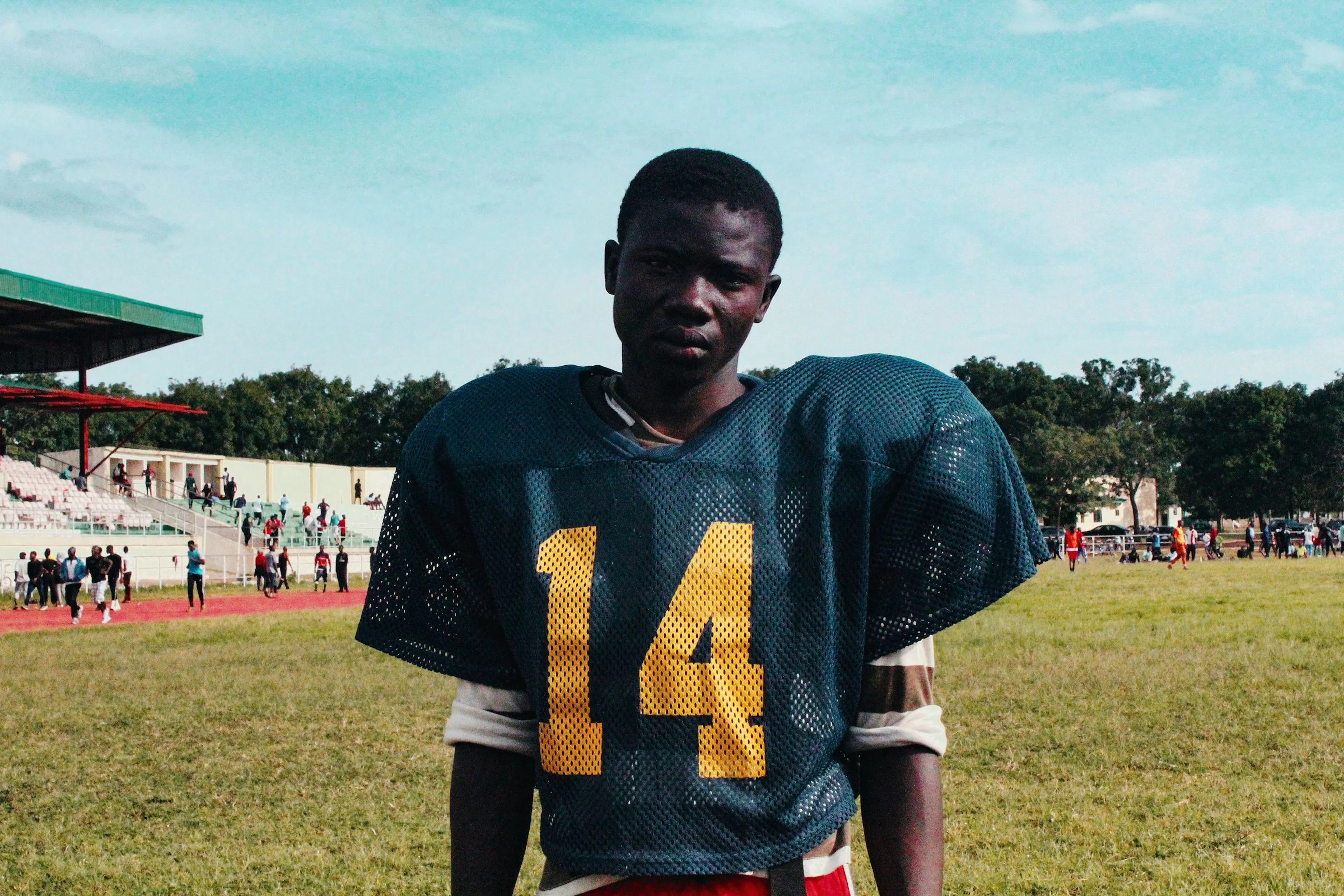 Football player in a number 14 jersey on a stadium field