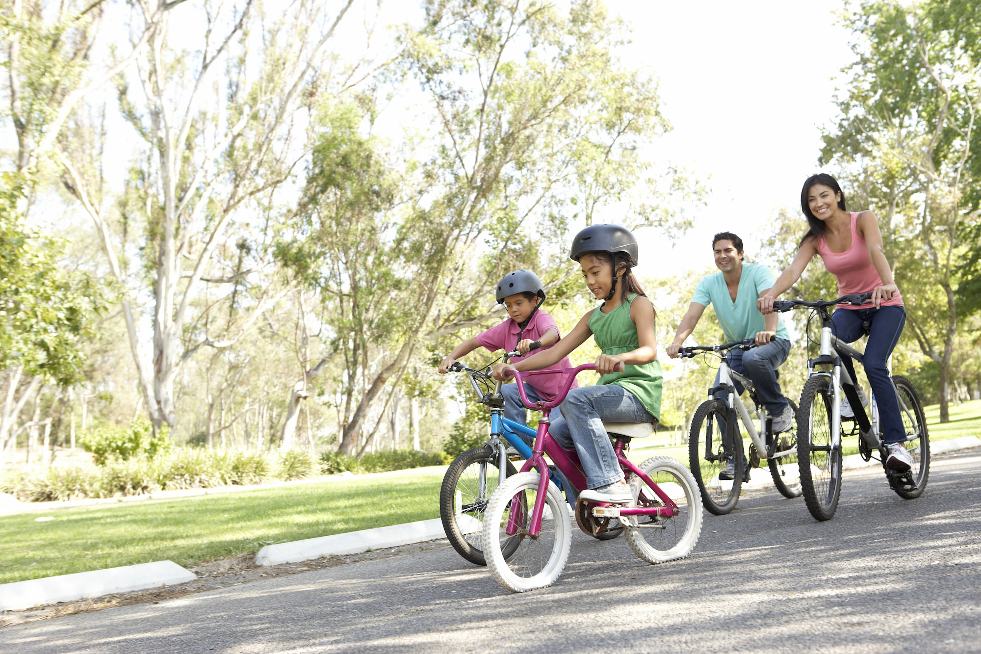Parents biking with their kids.