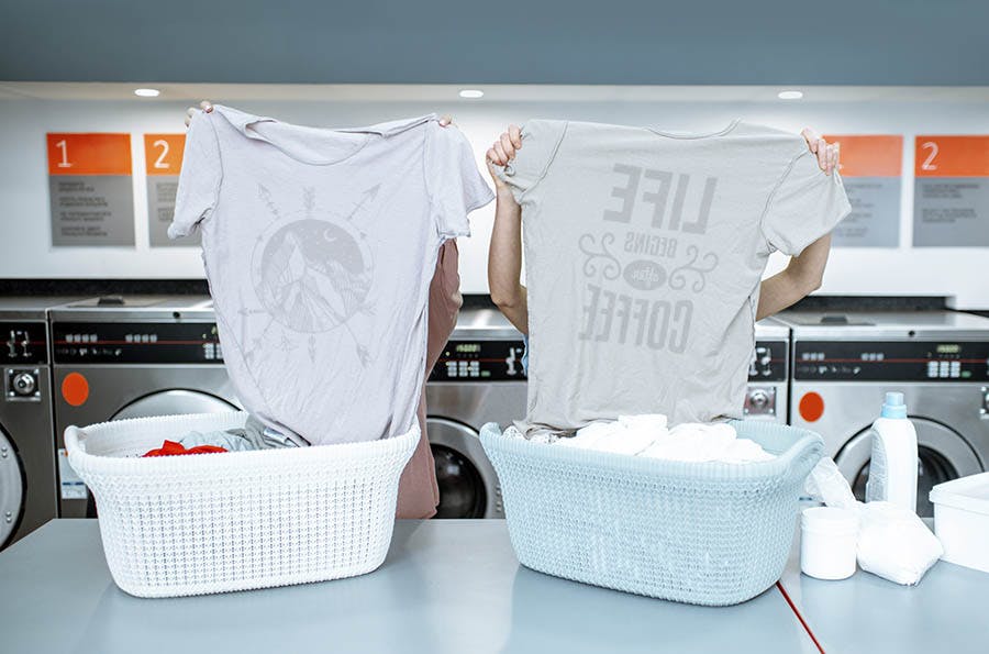 Showing a couple turning T-shirts inside-out before washing them.