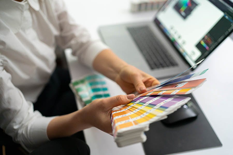 Designer choosing her Pantones from the color book.