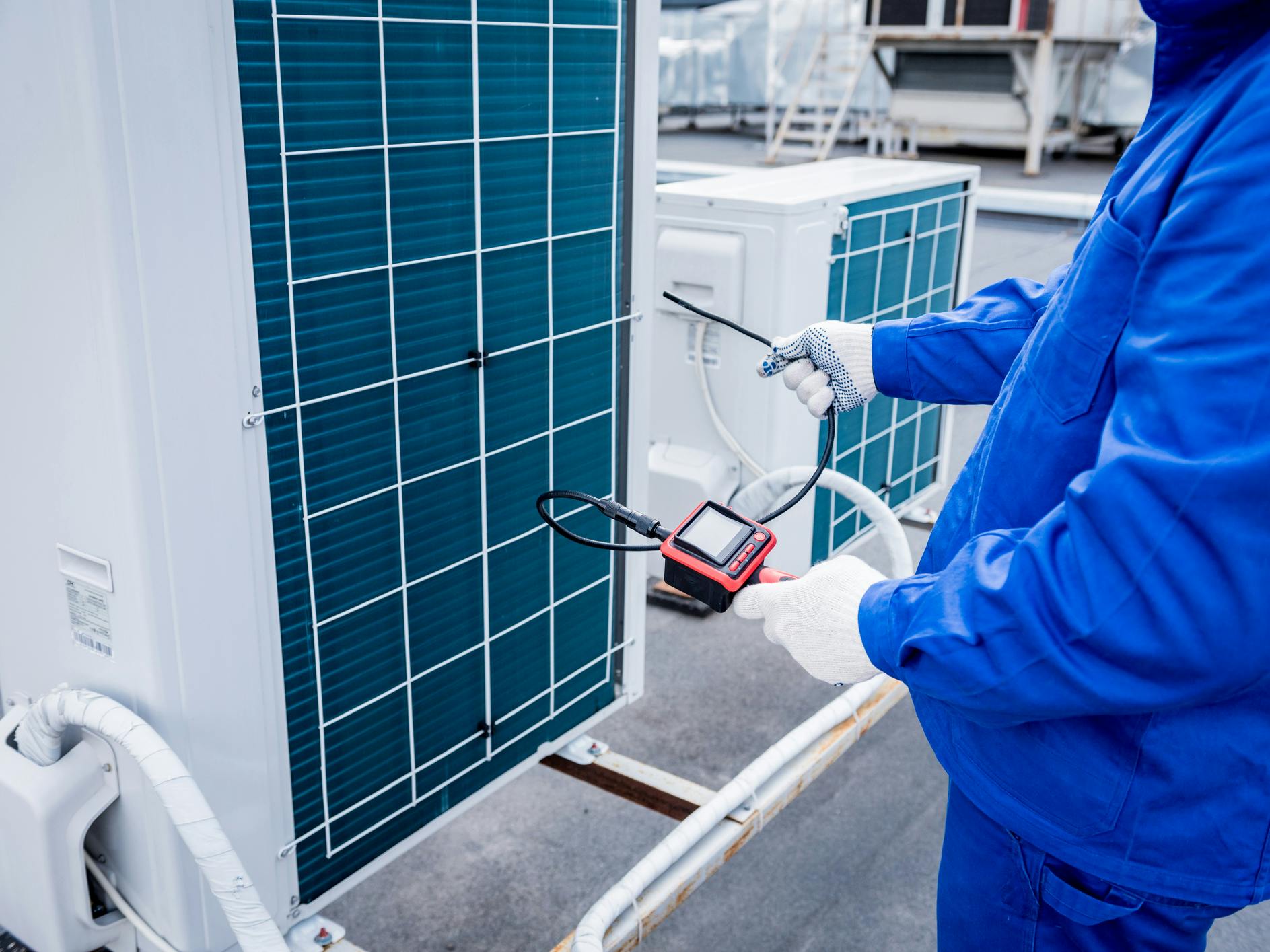The technician uses a digital camera to check the clogging of the heat exchanger