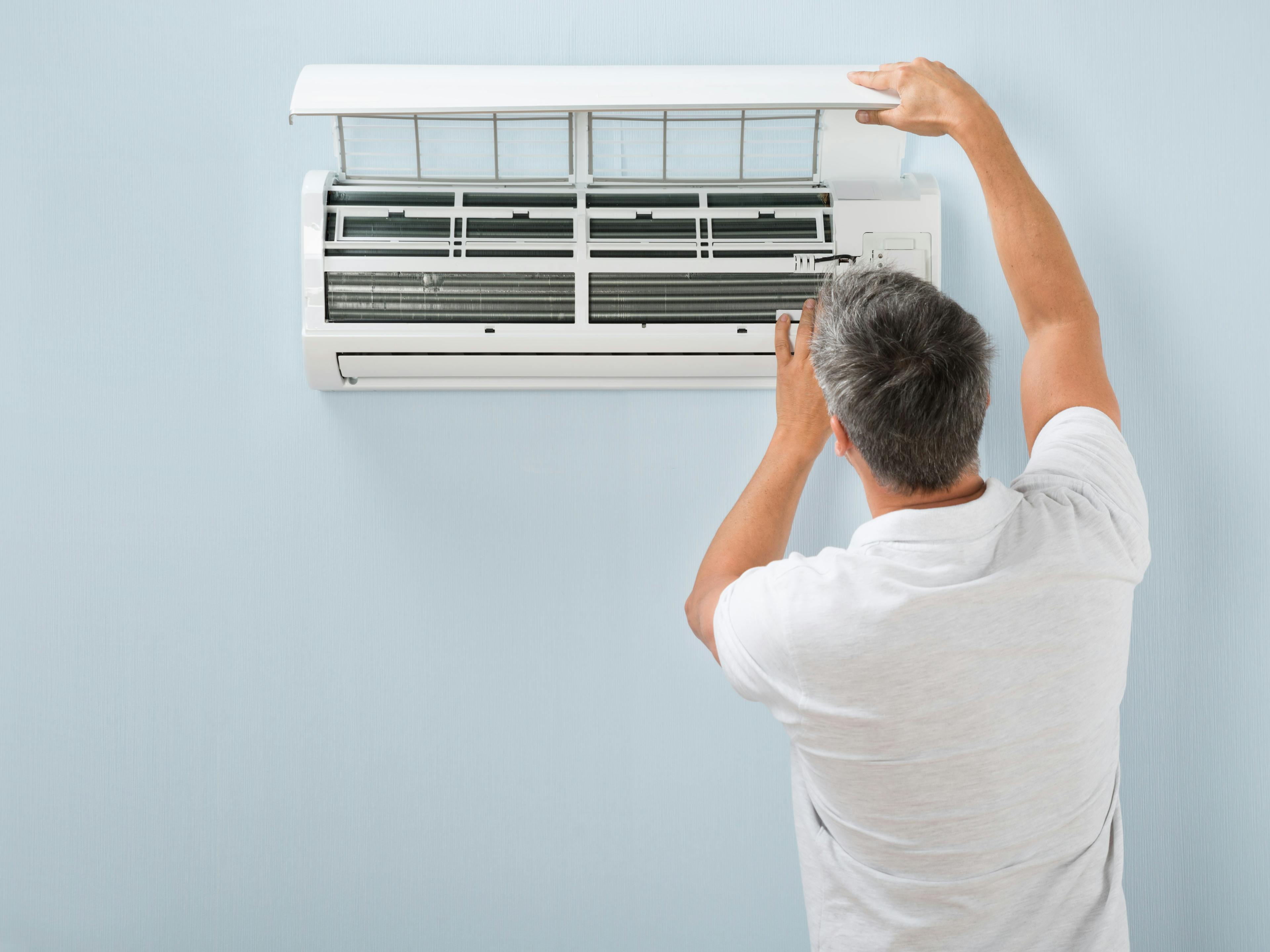 Man checking air conditioning mini split