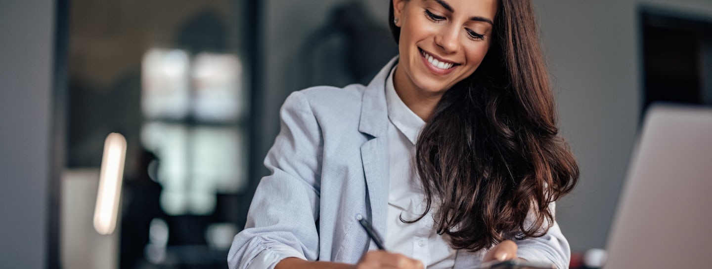 A woman smiling in a safe environment covered by cybersecurity services from s01ve Ltd.