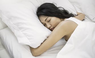 person sleeping on side on innerspring mattress