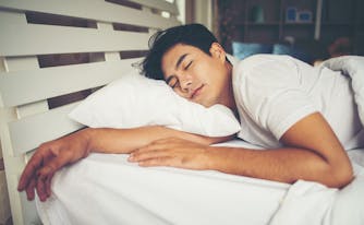 person sleeping on pillow in bed