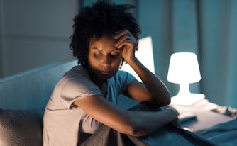 person with high cortisol levels looking stressed in bed