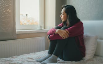person with somniphobia staring out window