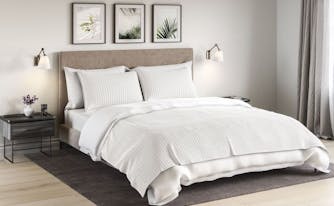 saatva cotton blanket on top of bed