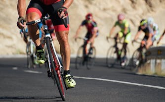 group of triathletes riding bicycles