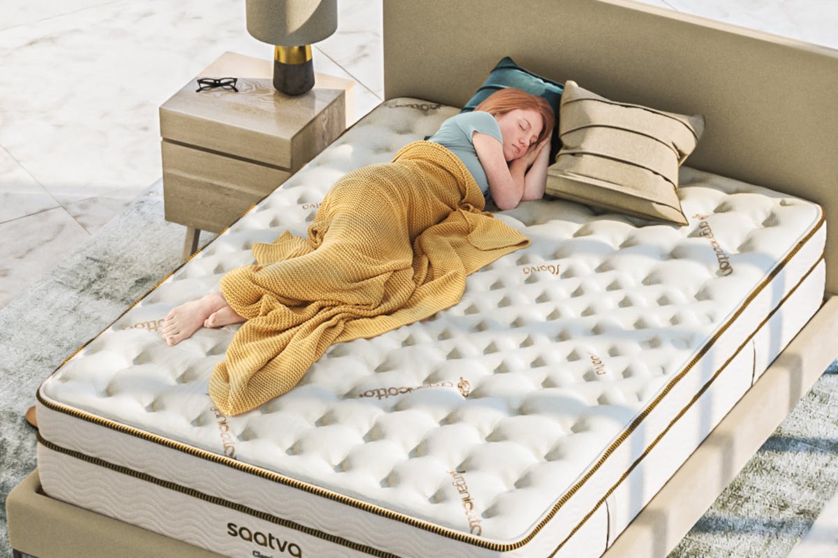 person with back pain sleeping on mattress