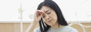 menopause and sleep - middle-aged person with headache