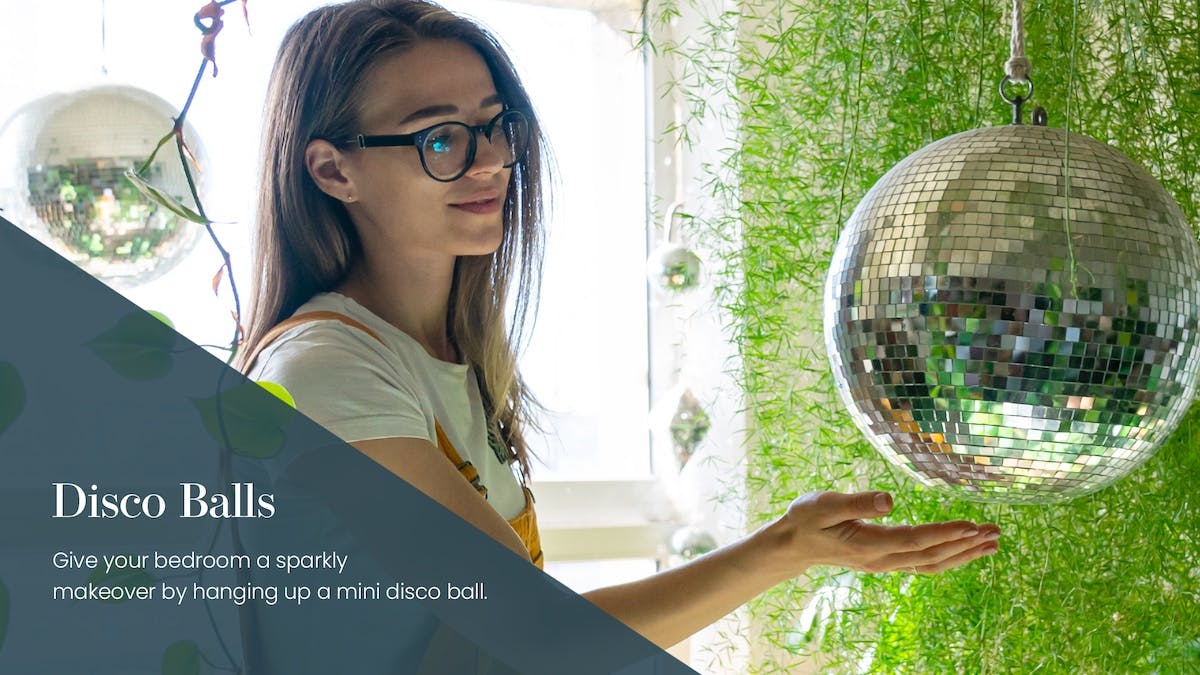 person hanging disco ball in bedroom