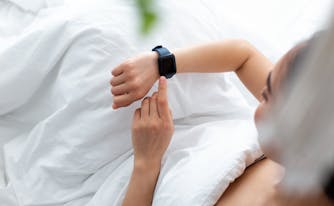 person looking at sleep tracker on list