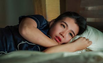 depressed person lying in bed