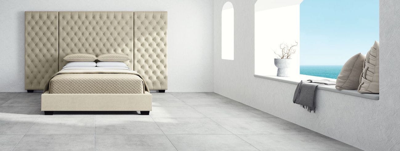 Panel bed frames have a large headboard, side railings, and a footboard. (Saatva Marbella panel bed seen here.)