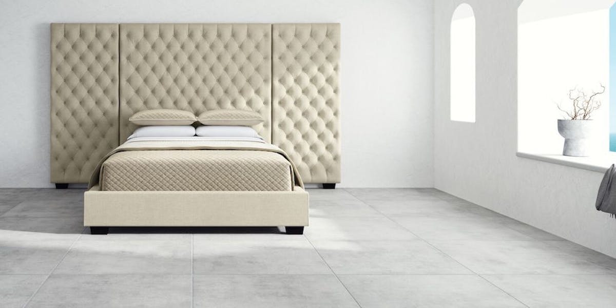 Panel bed frames have a large headboard, side railings, and a footboard. (Saatva Marbella panel bed seen here.)