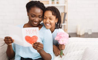 child giving mom a mother's day gift
