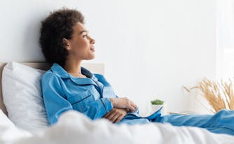person looking at window thinking about when to go to sleep