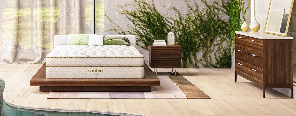 saatva classic innerspring mattress inside forest-themed bedroom